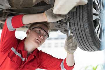 Mechanic. Auto service shop. Mechanic repair automobile axle, suspension and disc brake in auto...