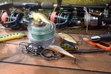 Fishing items laid out on a table against a wooden, old background.