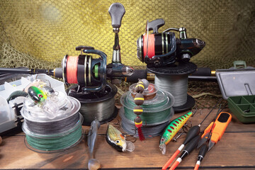 Fishing items laid out on a table against a wooden, old background.