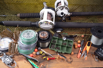 Fishing tackle on a table in a composition with fishing accessories