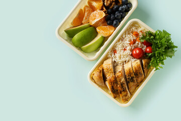 Lunch box with chicken, rice, vegetables, tomatoes, salad,