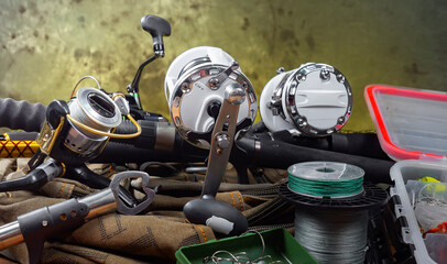 Fishing items laid out on a table against a wooden, old background.