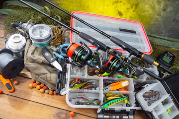 Fishing items laid out on a table against a wooden, old background.