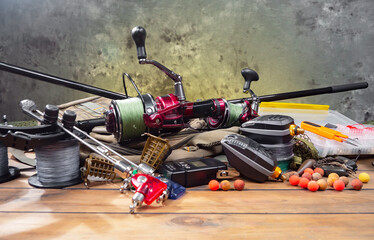 Fishing items laid out on a table against a wooden, old background.