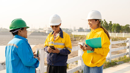 Construction Workers Discuss Project Updates at a Construction Site During Sunny Daytime