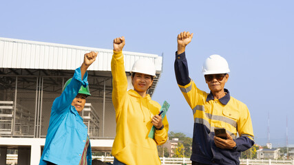 Workers Celebrate Achievement During Team Rally at Construction Site in Sunny Weather, Showcasing...