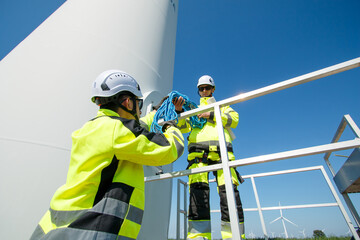 Team of electrical engineer is perform the inspection and maintenance of electric generating windmill turbine.