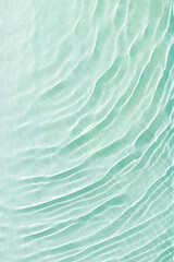 Clear water and waves at sunlight, sun flare and bright white reflections on blue, turquoise water...