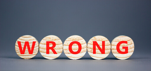 Wrong symbol. Concept word Wrong on beautiful wooden circles. Beautiful grey table grey background....