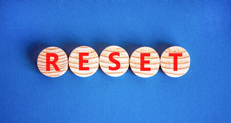 Reset symbol. Concept word Reset on beautiful wooden circles. Beautiful blue table blue background....