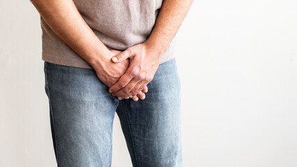 Man holding genitals. Men's health, venereologist, sexual disease