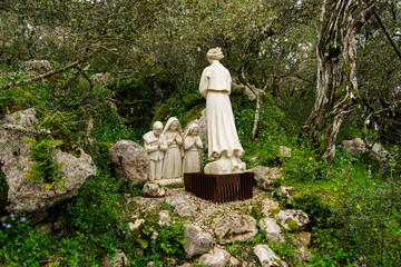 Religious statues in nature at Fatima, Portugal, surrounded by greenery and trees