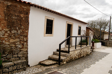 Traditional house with stone wall in Fatima, Portugal on a cloudy day