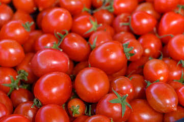 Vibrant cherry tomatoes showcase fresh produce at an open-air market in summer