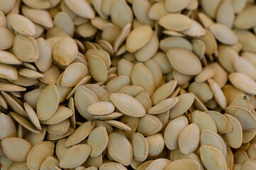 Harvesting pumpkin seeds for autumn celebrations and seasonal festivities in a cozy kitchen setting