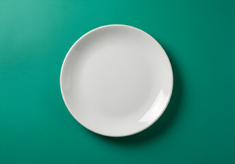 Top View of Clean White Ceramic Plate on Green Background | Minimalist Empty Round Dish for Food Presentation, Product Mockups, or Kitchen Design