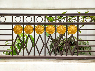 iron fence with an attractive combination of golden metal sunflower decoration,