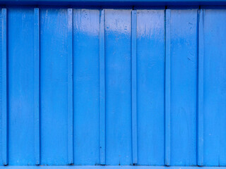 Blue wooden window with closed shutters and white wall of java house in Indonesia