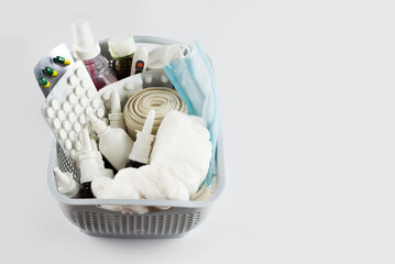Home medicine cabinet. Basket with medicines, pills, bottles, injections isolated on white