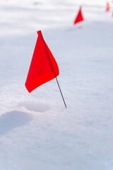 Red flag on snow, danger warning