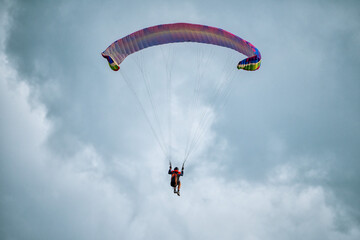 Parachute is filling with air in the mountains alps on a sunny day