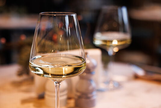 Elegant evening dining experience with fine wine at a cozy restaurant setting