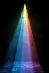 Vibrant rainbow light beam illuminating a dark stage with water reflection creating a magical atmosphere and visual depth