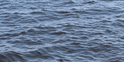 Natural ripples on blue water surface, texture as a background