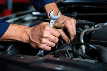 Man master repairs under the hood of the car