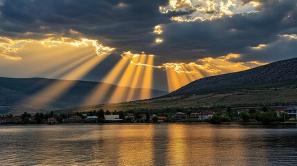 Soft golden sunlight breaks through scattered clouds, bathing the mountains and sea in warmth.