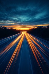 Obraz premium Sunset streaks across the highway as cars speed towards the horizon, a vibrant display of motion and color.