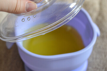 purple wax warmer containing melted yellow wax white waxing strips home professional waxing session hair removal treatments beauty skincare tutorial salon spa services removal kits waxing accessories