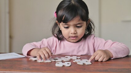 A young girl concentrating on solving a puzzle