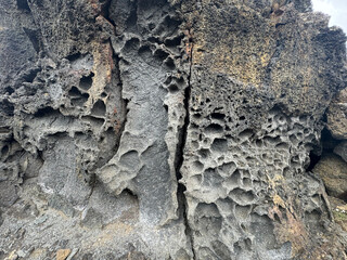 close up of a molten lava rock formation showing the porous holes in the brittle stone