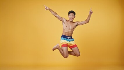 Obraz premium A person jumps through the air without a shirt on, perfect for action or sports scenes