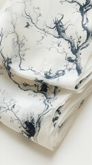 A pile of thin white paper is adorned with detailed hand-drawn illustrations of barren trees and mysterious creatures i