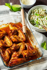 Waldorf salad with celery, apple and nuts, dressed with mayonnaise and spicy baked chicken wings.