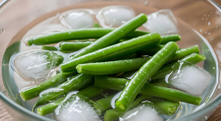 Fresh green beans submerged in ice water to halt the cooking process perfectly