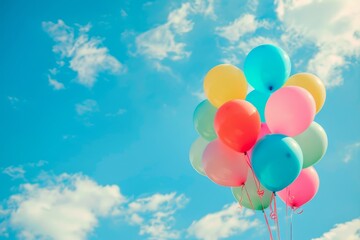 Colorful air balloons over blue sky and sun shining through clouds.