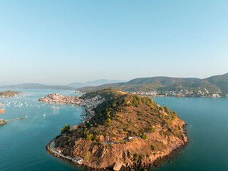 Aegean paradise Poros Island with peaceful harbor, anchored boats, traditional Greek architecture. Beautiful coastal town with Mediterranean charm, summer resort vibes relaxing seaside. Travel, nature