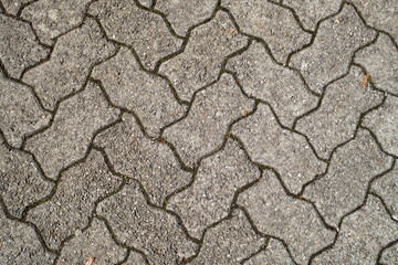 Top view of cobblestone pathway, patterned paving tiles, cement brick floor background, stone pavement