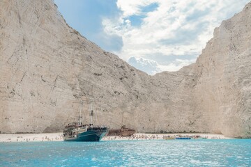 Bask in the warmth of summer on a hidden beach in Greece, surrounded by towering white cliffs....