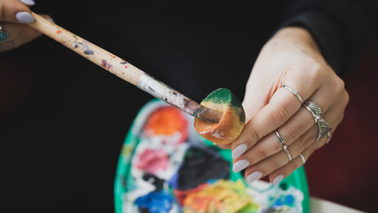 Woman Painting on Canvas with Brushes and Colors