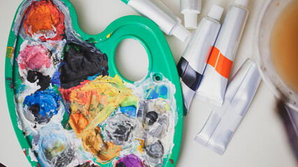 Woman Painting on Canvas with Brushes and Colors