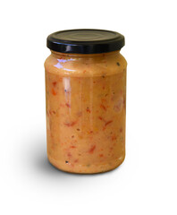 sauce in glass jar isolated on white background. Homemade sauce, seasoning, spicy paste. Bulgarian lyutenitsa, or Balkan ajvar, with tomatoes, eggplant, paprika, garlic. Traditional seasoning