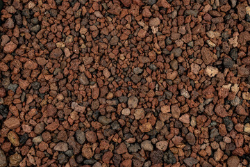 Close-up background texture of picón, lapilli, and reddish volcanic stones