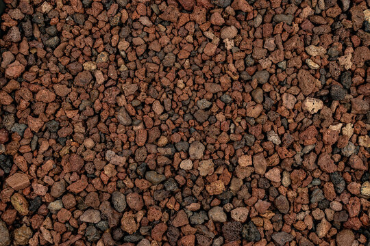 Close-up background texture of pic&oacute;n, lapilli, and reddish volcanic stones