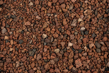 Close-up background texture of picón, lapilli, and reddish volcanic stones
