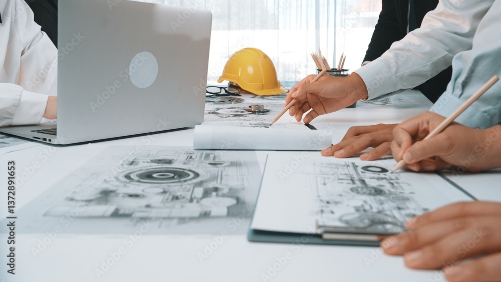 Aufkleber a dynamic team collaborates over engineering plans in a modern office setting. the scene captures ha