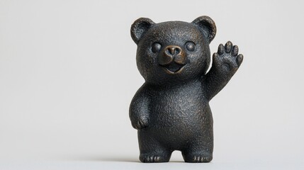 A small black bear figurine standing on its hind legs